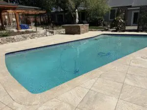 Pool with stone deck, blue tile and raised planter – Marin County