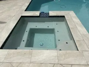 Raised spa with stone coping and paver deck – Marin County