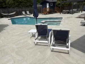 Pool and spa surrounded by light paver deck with lounge chairs – Marin County