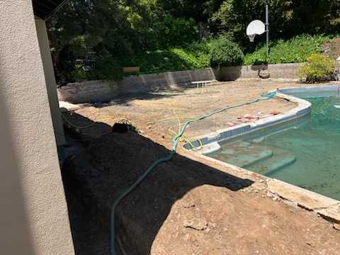 almost completed pool with dirty water and unfinished flooring