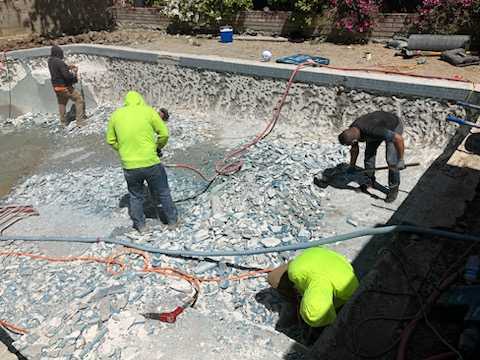 workers building an underground pool